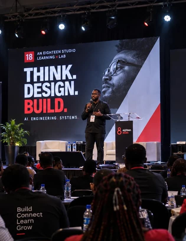 Illustration of a speaker on the Think, Design & Build stage in front of an audience.